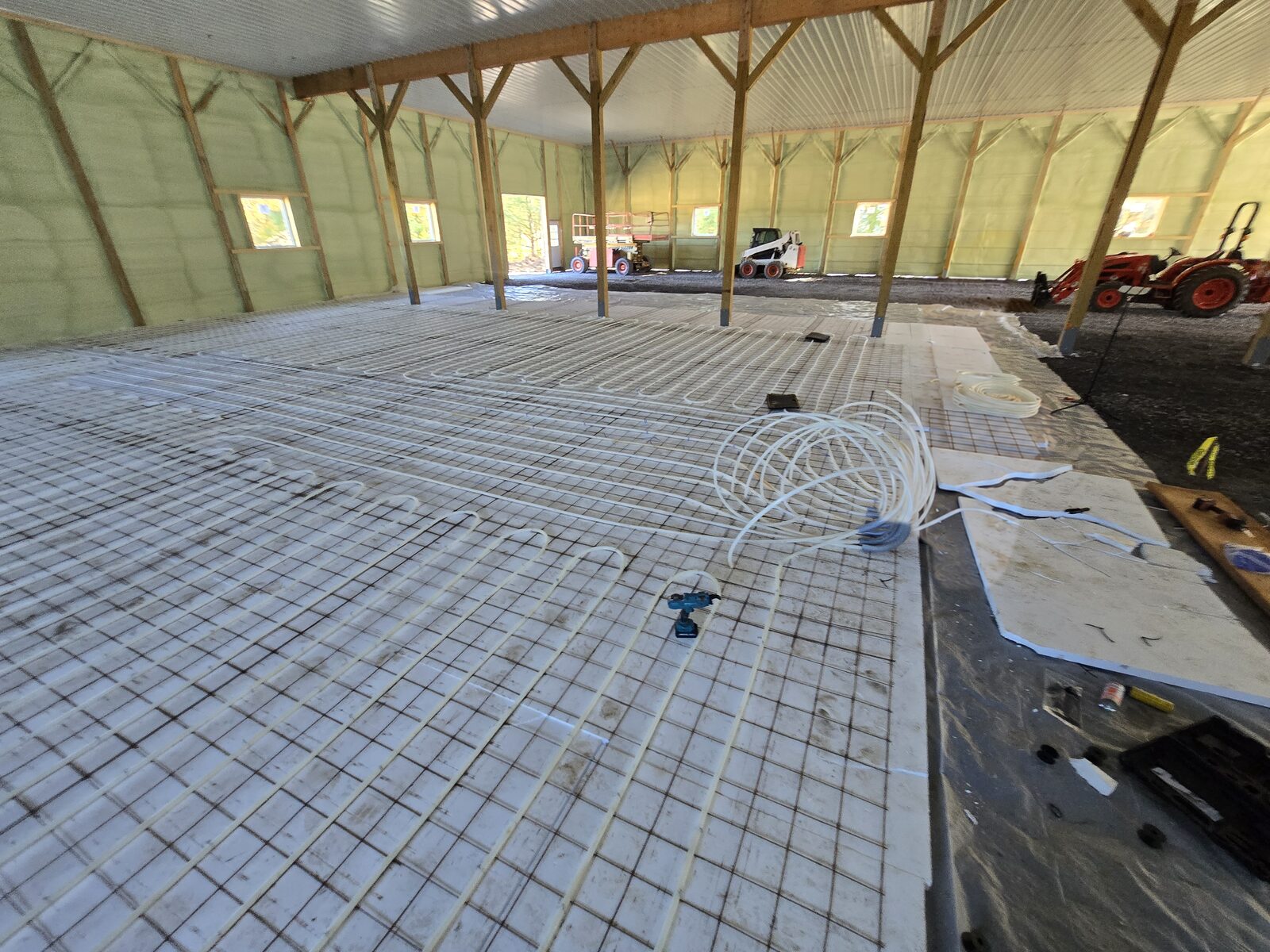 Loops returning toward the manifold area with a coil of PEX ready for the next loop
